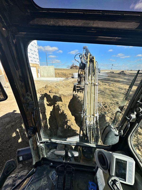 Basement dig for a new home viewed from inside the excavator cab